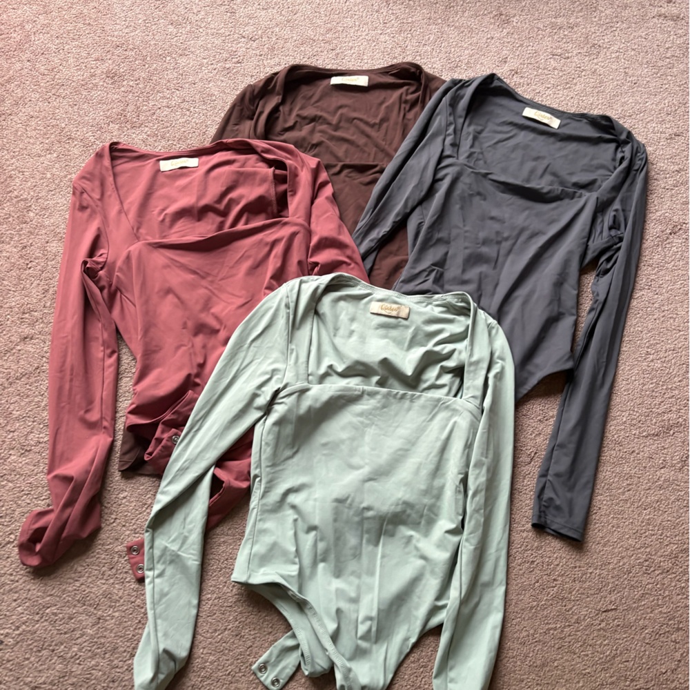 Brand new set of 4 Bodysuits